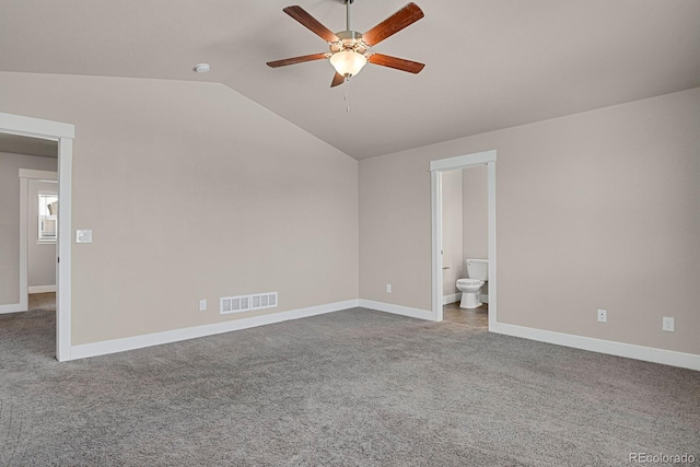 unfurnished bedroom with carpet, ceiling fan, vaulted ceiling, and ensuite bath