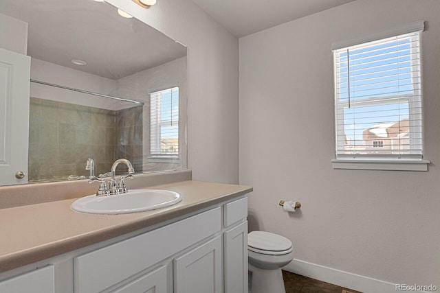 bathroom featuring a tile shower, tile patterned floors, vanity, and toilet