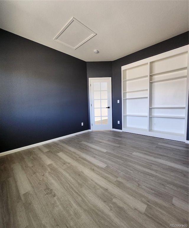 interior space featuring wood finished floors, baseboards, and a closet