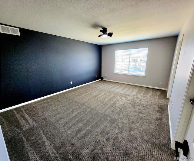 unfurnished bedroom featuring visible vents, a ceiling fan, a textured ceiling, carpet flooring, and baseboards