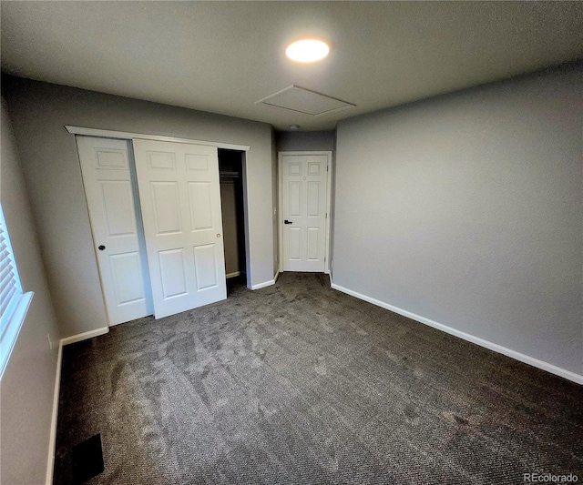 unfurnished bedroom with a closet, carpet flooring, and baseboards