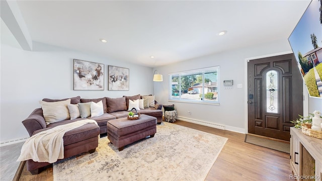 living room featuring a baseboard radiator and light wood-type flooring