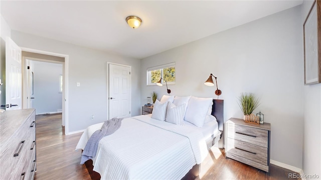 bedroom with dark wood-type flooring