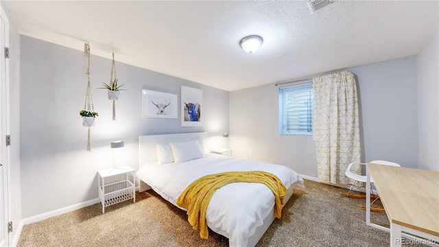 bedroom with a textured ceiling and carpet flooring