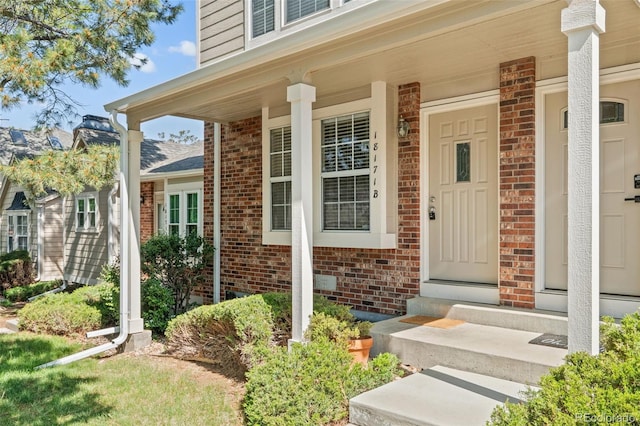 18171 E Arizona Ave Unit B, Aurora, CO 80017 - doorway to property with brick siding and a porch