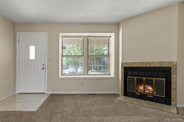 18171 E Arizona Ave Unit B, Aurora, CO 80017 - foyer entrance with carpet floors, a fireplace with flush hearth, baseboards, and a textured ceiling