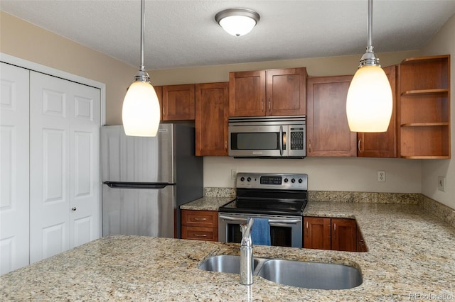 18171 E Arizona Ave Unit B, Aurora, CO 80017 - kitchen featuring appliances with stainless steel finishes, brown cabinetry, and pendant lighting