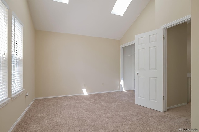 18171 E Arizona Ave Unit B, Aurora, CO 80017 - unfurnished bedroom featuring light carpet, multiple windows, a skylight, baseboards, and high vaulted ceiling