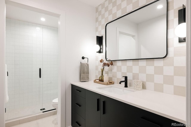 bathroom featuring a shower with shower door, decorative backsplash, tile patterned flooring, vanity, and toilet