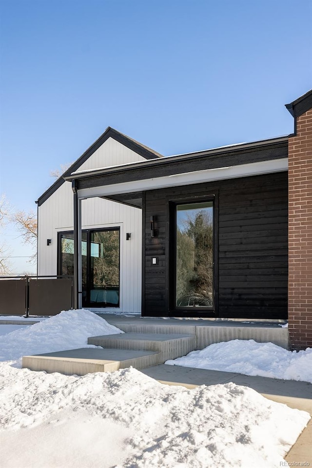 view of snow covered property entrance