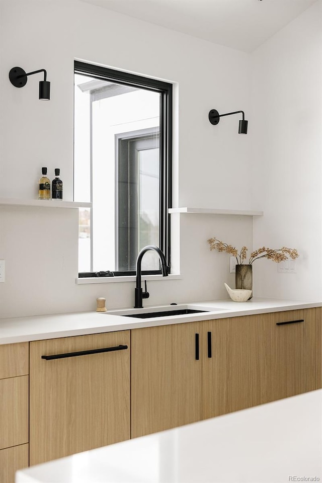 interior space featuring light brown cabinetry and sink