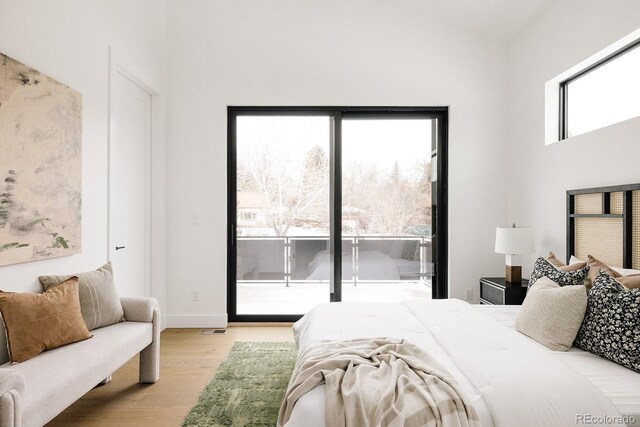 bedroom with light hardwood / wood-style floors and access to outside