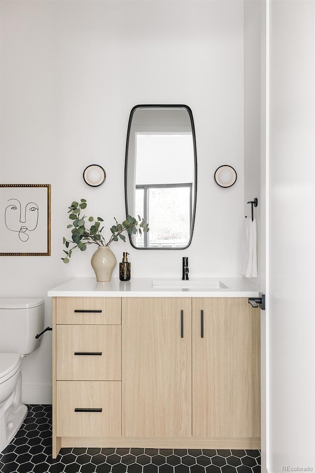 bathroom featuring vanity and toilet