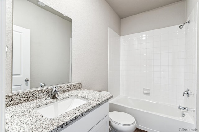 full bathroom featuring vanity, bathtub / shower combination, and toilet