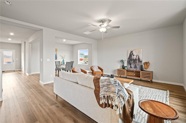 living room featuring ceiling fan and wood-type flooring