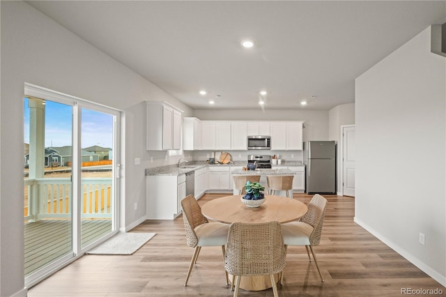 dining area featuring light wood-type flooring