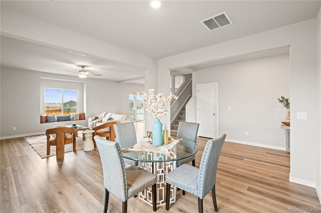 dining space featuring ceiling fan and light wood-type flooring