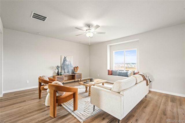 living room featuring hardwood / wood-style flooring and ceiling fan