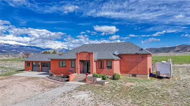 view of front of property with a garage and a mountain view