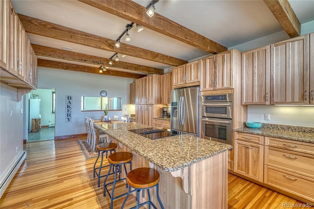 kitchen featuring appliances with stainless steel finishes, beam ceiling, and light hardwood / wood-style flooring