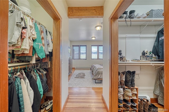 spacious closet featuring baseboard heating and wood-type flooring