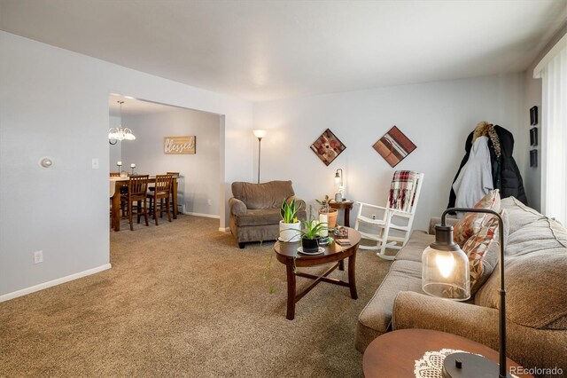 carpeted living room with a notable chandelier