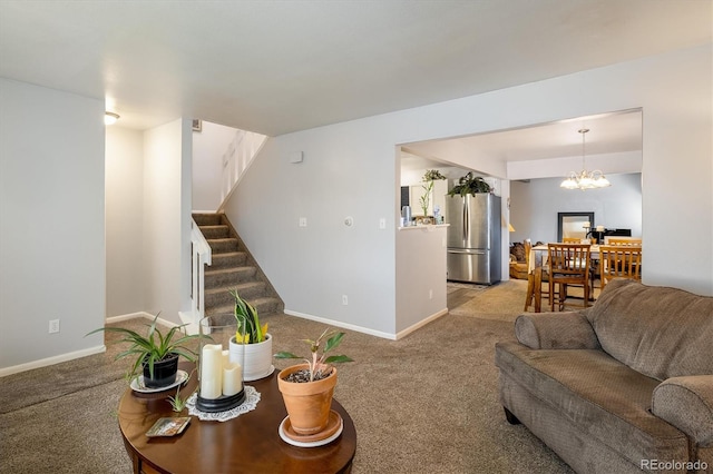 living room with a chandelier and carpet flooring