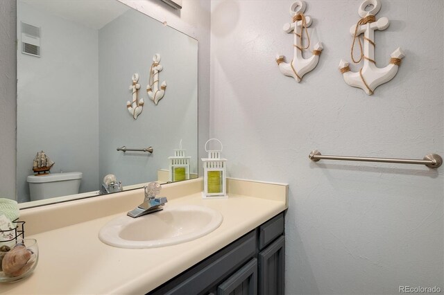 bathroom with vanity and toilet