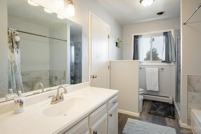 full bathroom with toilet, vanity, a baseboard radiator, hardwood / wood-style flooring, and shower with separate bathtub