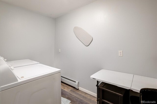 washroom featuring a baseboard heating unit, separate washer and dryer, and dark hardwood / wood-style floors