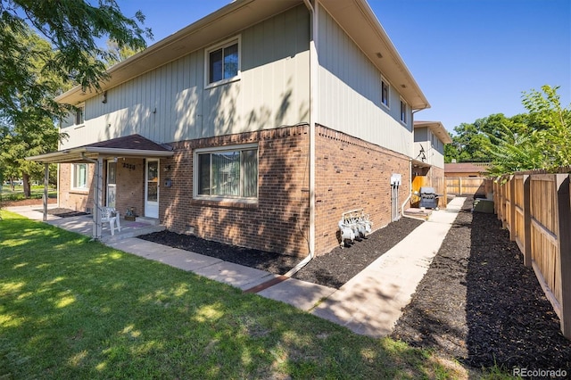 rear view of property with a yard