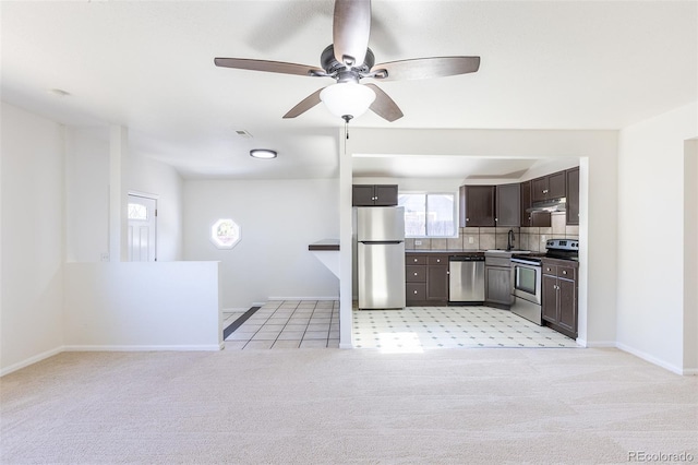 3570 Center Ave, Denver, CO 80219 - kitchen featuring stainless steel appliances, under cabinet range hood, dark brown cabinets, light carpet, and ceiling fan