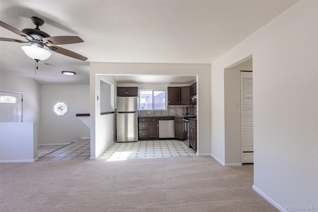 3570 Center Ave, Denver, CO 80219 - kitchen with appliances with stainless steel finishes, dark brown cabinetry, light carpet, a ceiling fan, and healthy amount of natural light