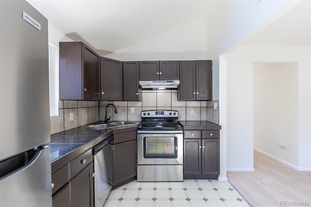 3570 Center Ave, Denver, CO 80219 - kitchen featuring appliances with stainless steel finishes, under cabinet range hood, tile counters, lofted ceiling, and backsplash
