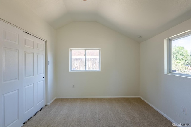 3570 Center Ave, Denver, CO 80219 - unfurnished bedroom featuring multiple windows, vaulted ceiling, and light colored carpet