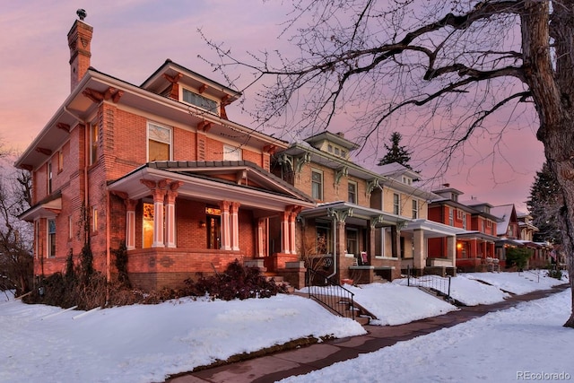 american foursquare style home with brick siding