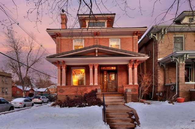 traditional style home with brick siding and a porch