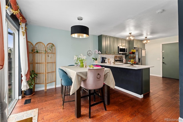 15104 E Utah Pl, Aurora, CO 80012 - dining space featuring visible vents, dark wood-style flooring, and baseboards