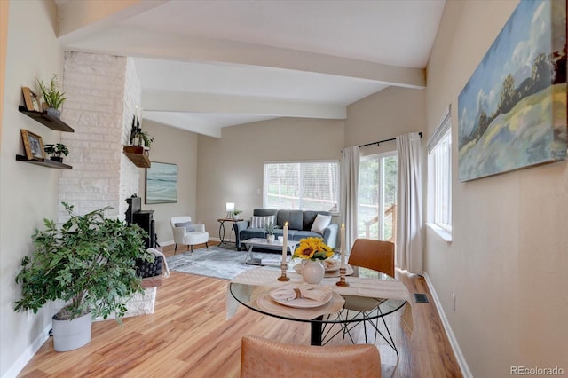 9288 Krashin Dr, Conifer, CO 80433 - living room featuring beamed ceiling, wood finished floors, and baseboards