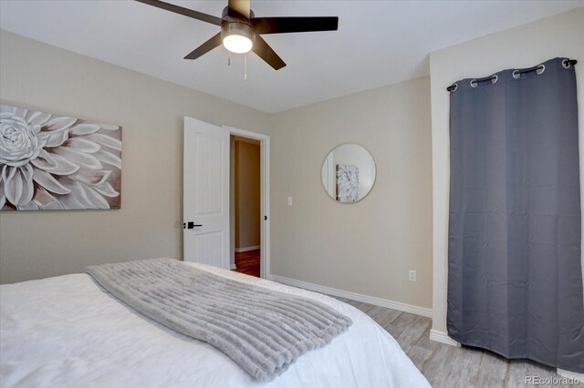9288 Krashin Dr, Conifer, CO 80433 - bedroom featuring wood finished floors, a ceiling fan, and baseboards