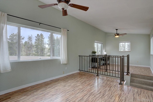 9288 Krashin Dr, Conifer, CO 80433 - empty room featuring a ceiling fan, vaulted ceiling, baseboards, and wood finished floors