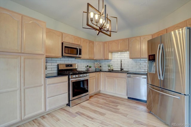9288 Krashin Dr, Conifer, CO 80433 - kitchen with stainless steel appliances, light brown cabinets, a sink, and dark countertops