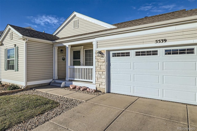 view of front of property with covered porch and a garage