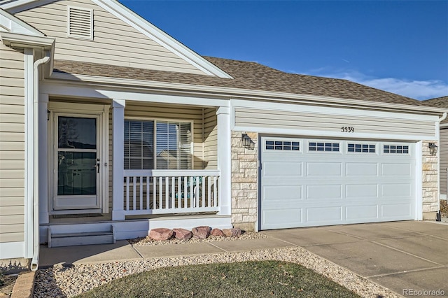 view of front facade featuring a porch and a garage