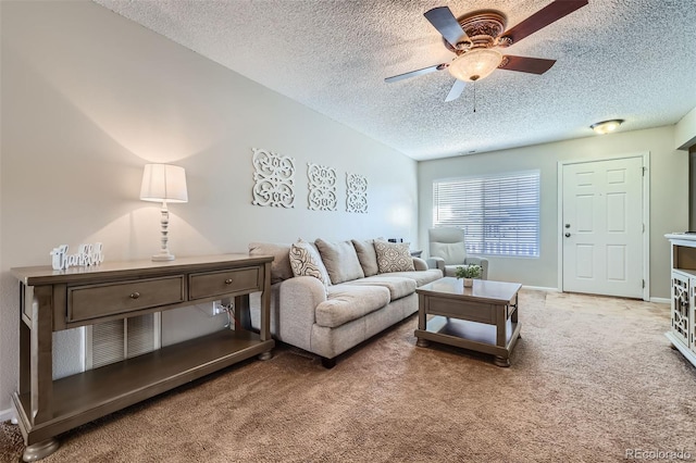 living room with carpet, ceiling fan, and a textured ceiling