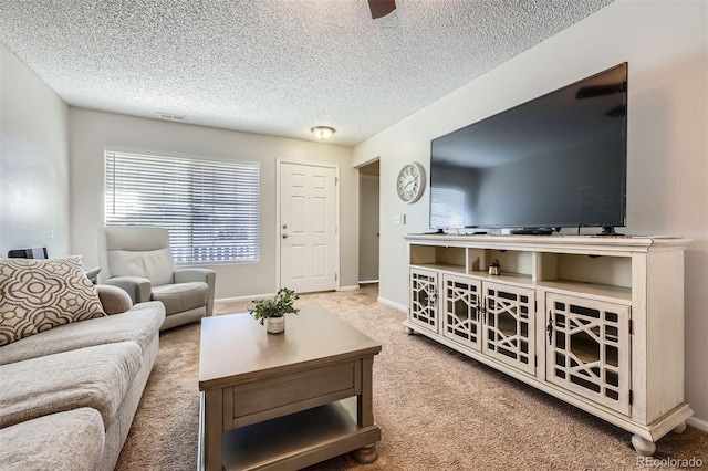 carpeted living room featuring a textured ceiling