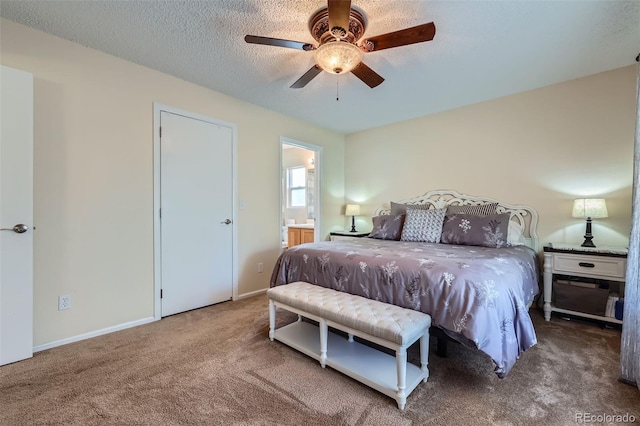 bedroom with carpet flooring, a textured ceiling, ensuite bathroom, and ceiling fan