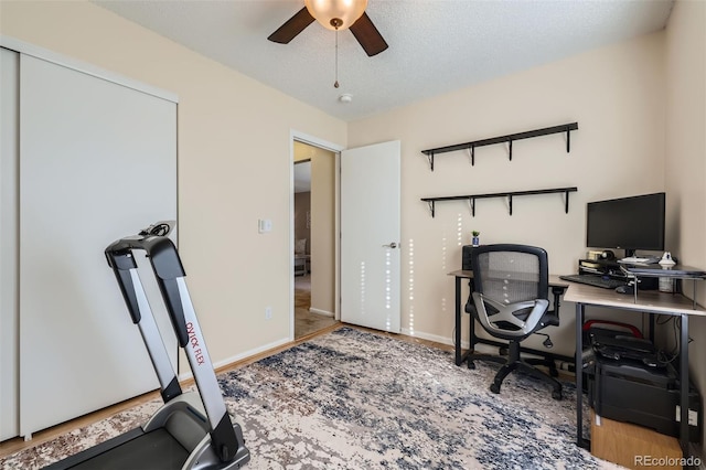 office space with a textured ceiling and ceiling fan