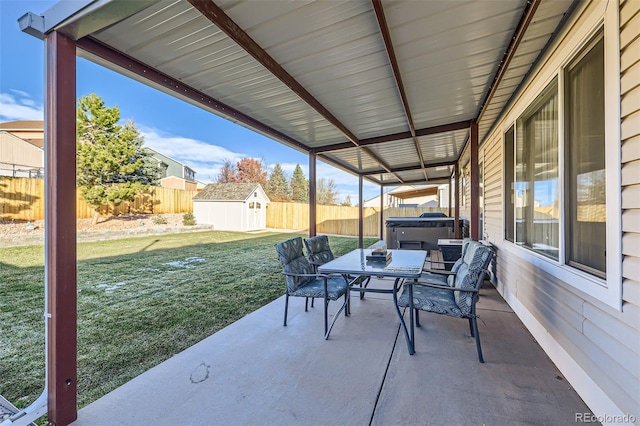 view of patio featuring a storage unit and a hot tub