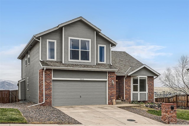 16645 W 2nd Ave, Golden, CO 80401 - traditional home with a garage, concrete driveway, brick siding, and a shingled roof